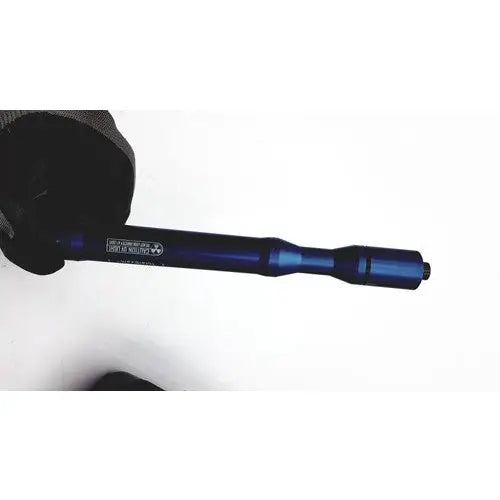 Blue metallic bicycle crank arm held in gloved hand for GlobalMedia TotalExam handheld medical examination device