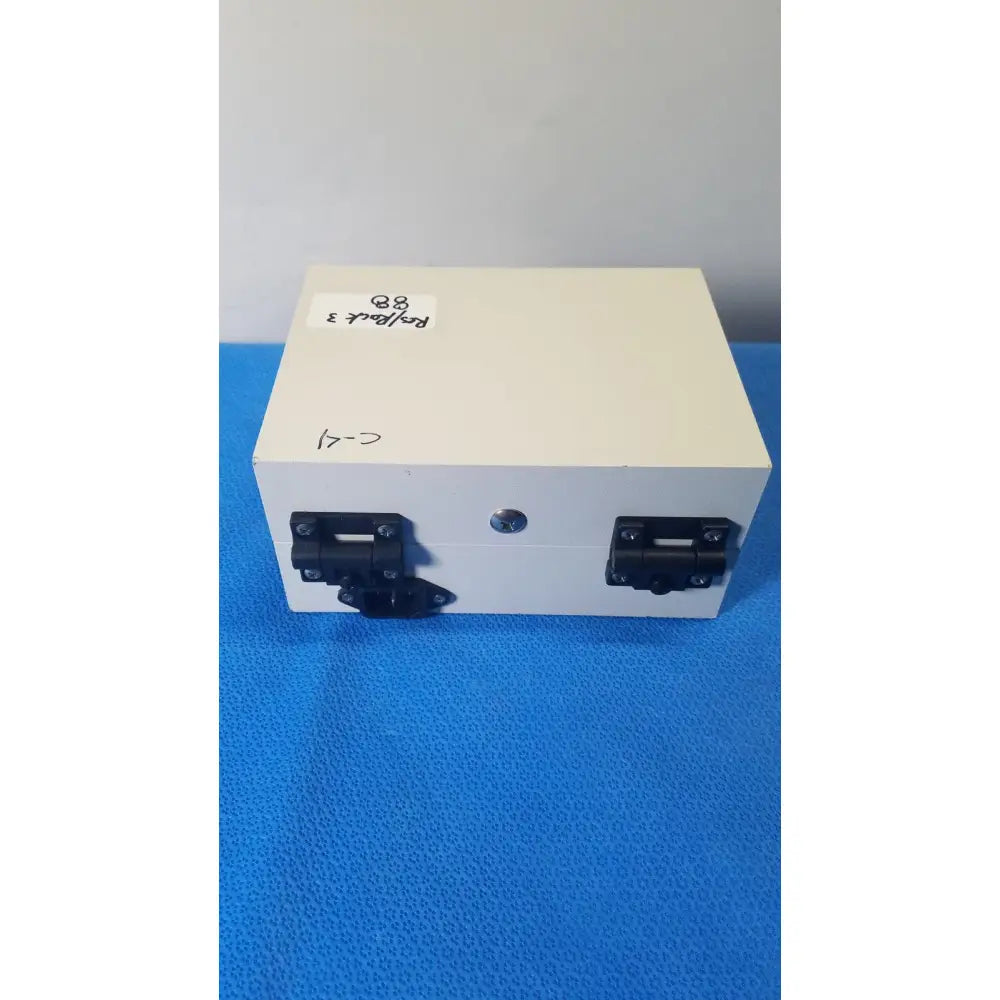 White rectangular gms general microwave receiver monitor with black metal latches and circular lock for c f band use