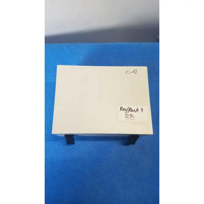 A cream-colored gms general microwave c f band 6.2-6.8 GHz receiver monitor with black stand supports and minimalist design