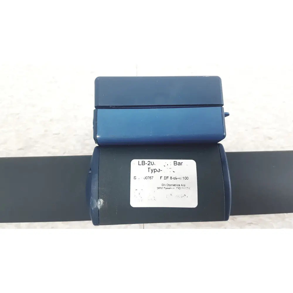 Blue plastic bar clamp with white label showing technical specifications for gn otometrics lb-200 portable light bar