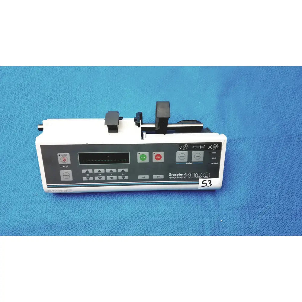 White graseby 3100 syringe delivery device with black control panel, green and red buttons, and mechanical loading for device clean medical use