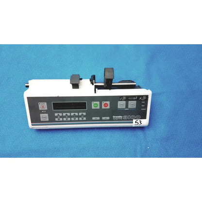 White graseby 3100 syringe delivery device with black control panel, green and red buttons, and mechanical loading for device clean medical use