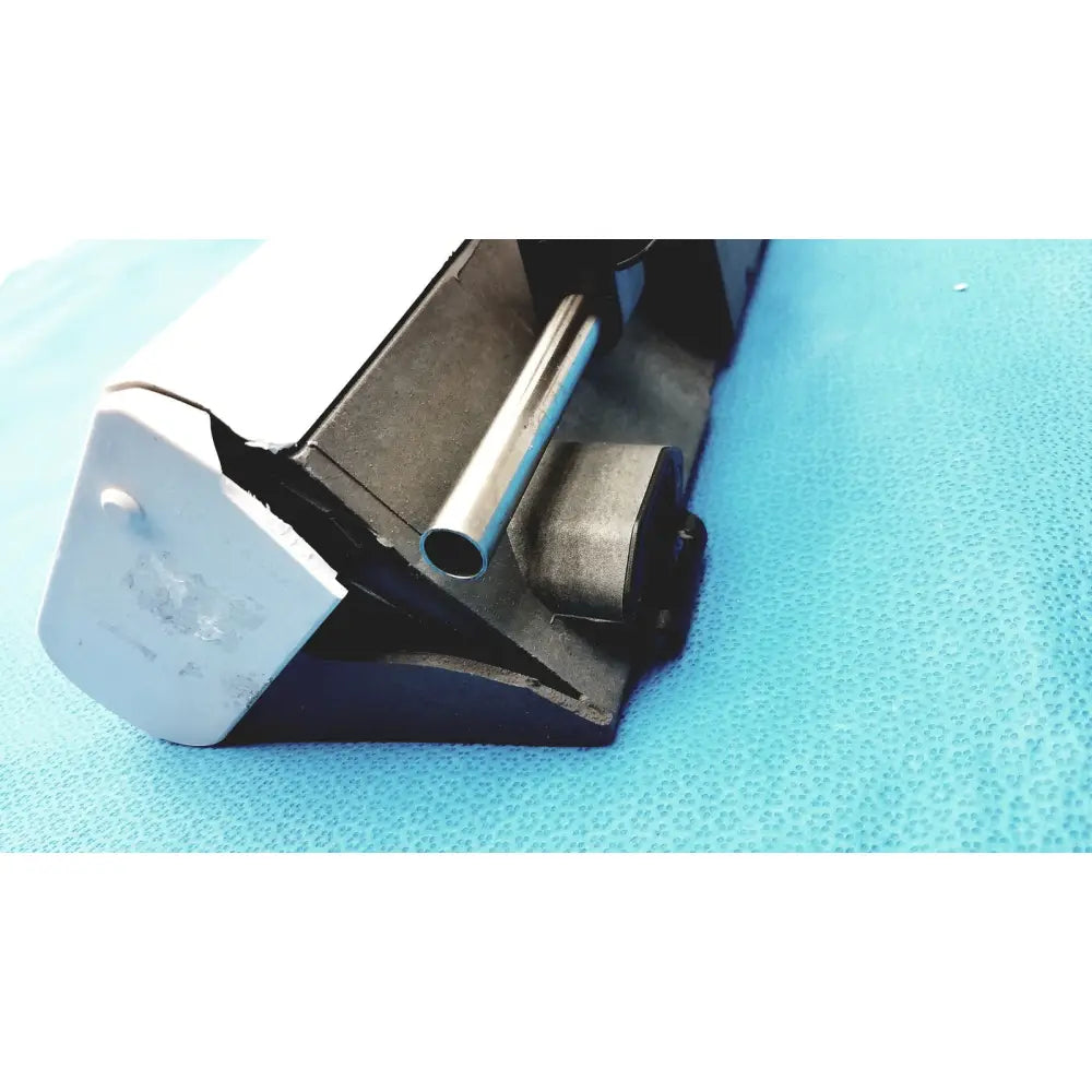 Black and white plastic clamp holding silver metal rod on the Graseby 3100 syringe delivery device clean medical unit