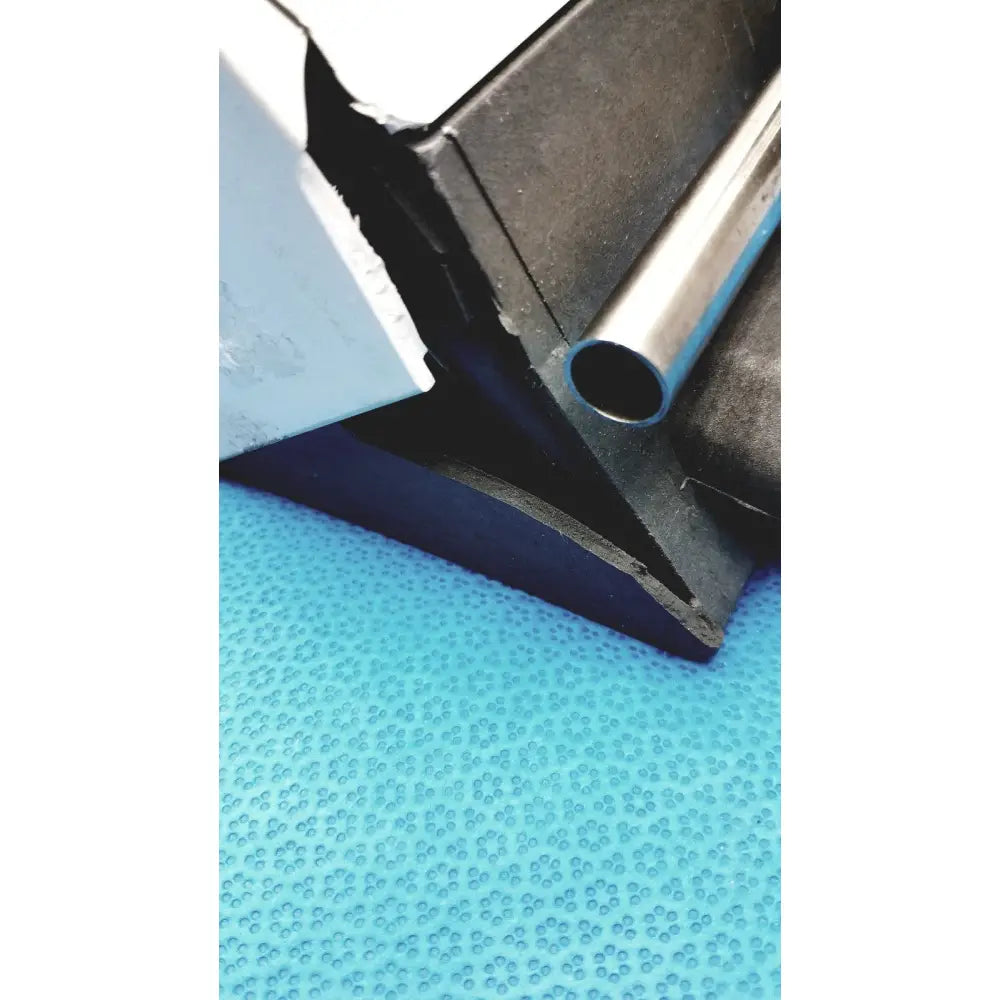 A sleek metallic silver graseby 3100 syringe delivery device clean unit resting against dark rubber material