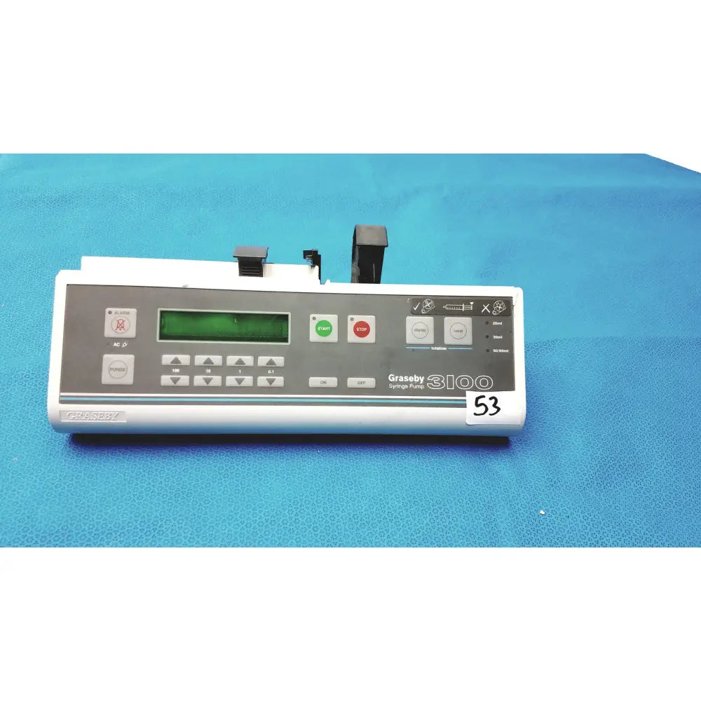 White graseby 3100 syringe delivery device with green digital display and gray control panel on blue surface device clean medical unit