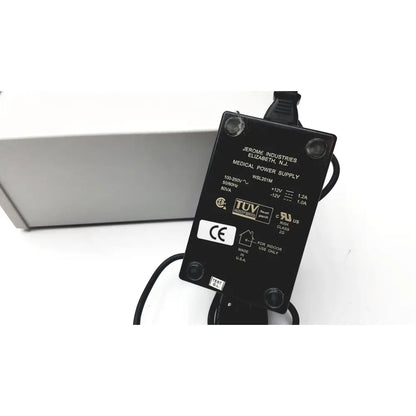 Black rectangular medical power supply adapter with specifications labels on the back for grass 15lt physiodata amplifier system