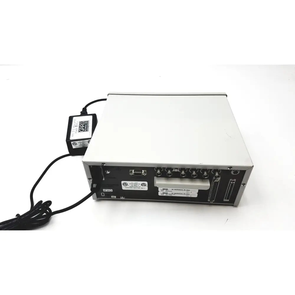 Silver and black grass 15lt physiodata amplifier system with multiple ports and connected power supply at the back side