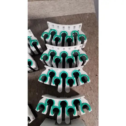 White plastic grifols cards clips with green rubberized grips and black inserts for dilution trays and evaporation caps
