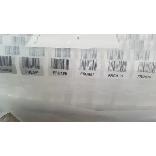 White barcode labels with black codes affixed to translucent plastic for grifols cards dilution trays evaporation caps