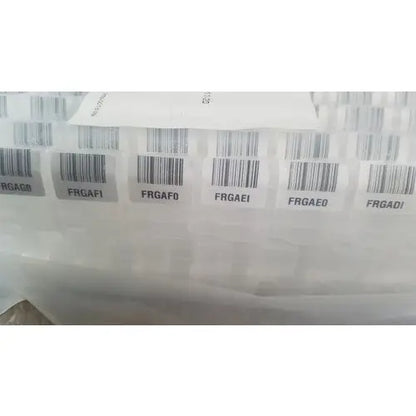 White barcode labels with black codes affixed to translucent plastic for grifols cards dilution trays evaporation caps