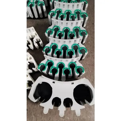 White and green plastic cable clips with black circular inserts for grifols cards dilution trays and evaporation caps