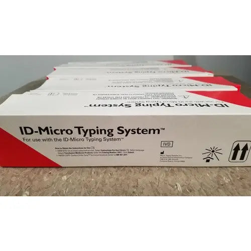 White and red cardboard box for id-micro typing system featuring grifols cards dilution trays and evaporation caps packaging