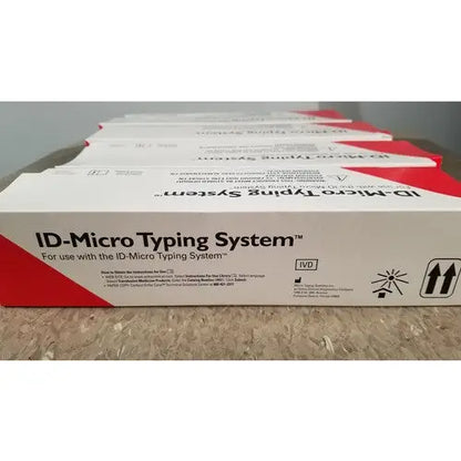 White and red cardboard box for id-micro typing system featuring grifols cards dilution trays and evaporation caps packaging