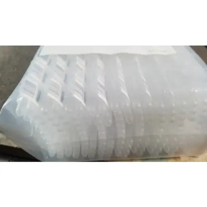 Clear plastic water bottles stacked in transparent bag for grifols cards dilution trays and evaporation caps use