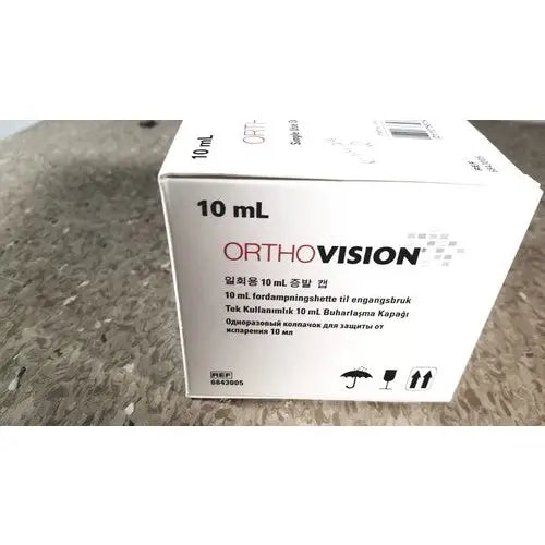 White cardboard box for orthovision 10 ml eye drop solution displayed with grifols cards and dilution trays for reuse medical applications
