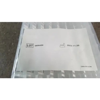 White paper label with black text and icon on clear plastic packaging for grifols cards and dilution trays reuse medical supplies