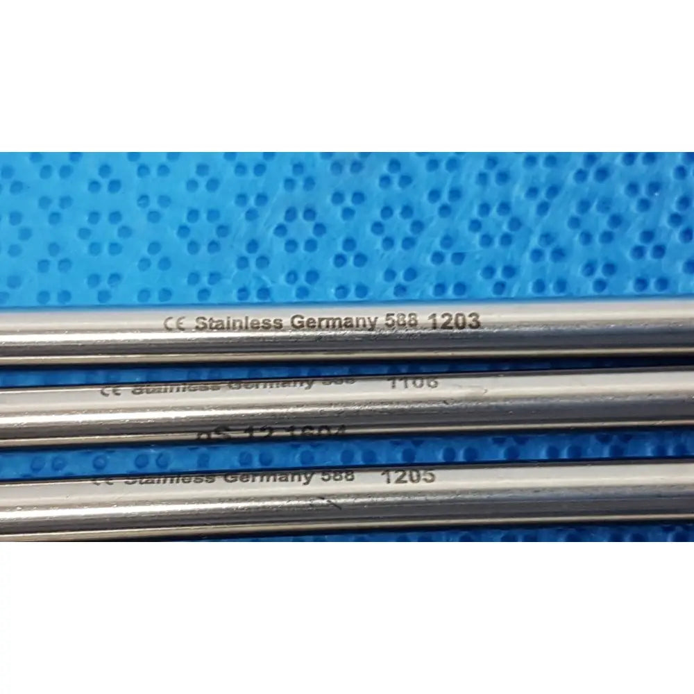 Four parallel german stainless steel surgical scalpel handles engraved with model numbers for precise medical use