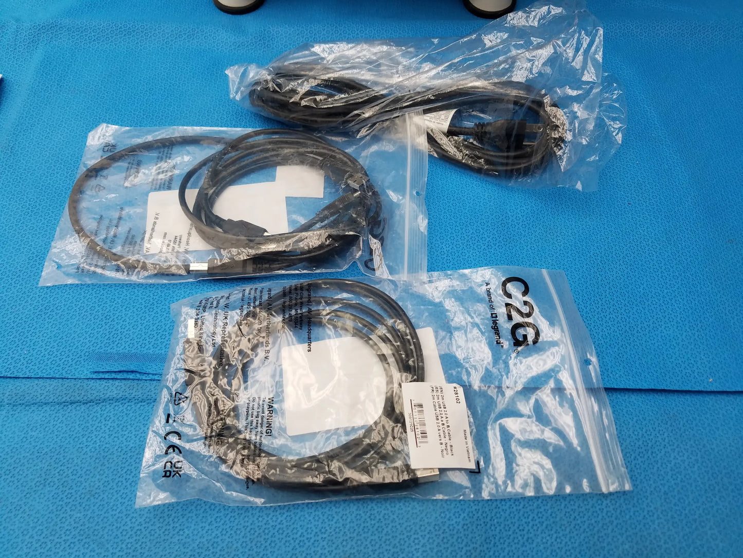 Black coiled usb cables in clear packaging with c2g branding for optical pill counter in pharmacy optical counting use
