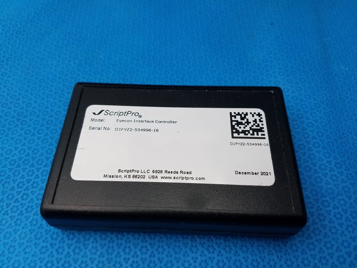 Black scriptpro eyecon interface controller with white label showing model serial number and qr code on back of gse eyecon 9400 optical pill counter for pharmacy optical pill counting
