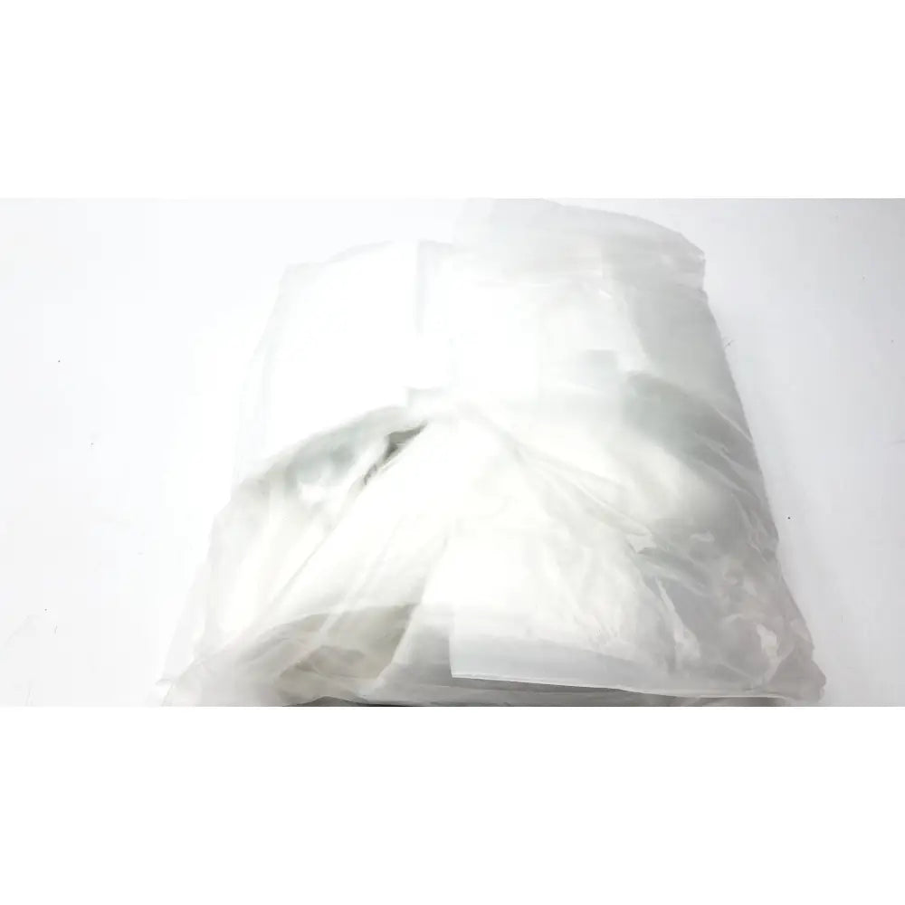 A crumpled translucent plastic bag containing a white garment for guldmann disposable gait trainer max 205 kg size large
