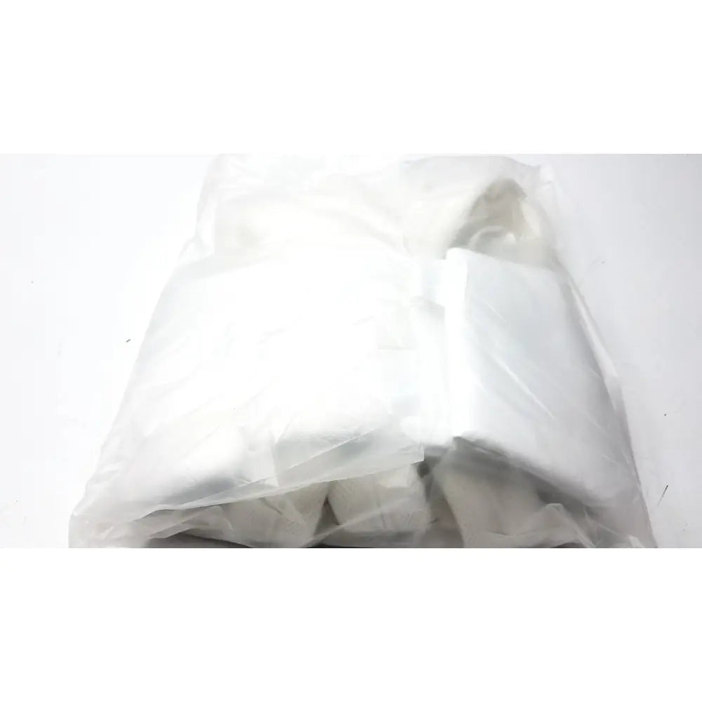 A crumpled transparent plastic bag containing a white folded garment for guldmann disposable gait trainer max 205 kg