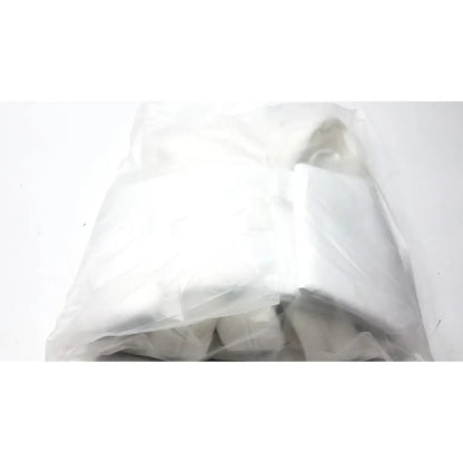 A crumpled transparent plastic bag containing a white folded garment for guldmann disposable gait trainer max 205 kg