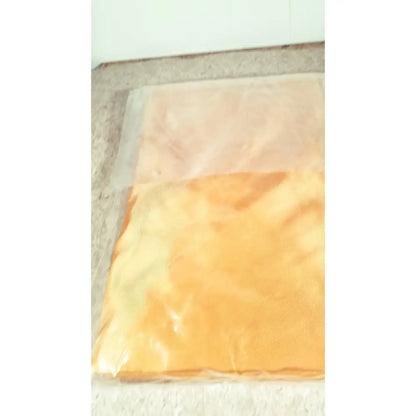 Orange and peach-colored fabric guldmann repositioning sling max 500 kg sealed in clear plastic packaging
