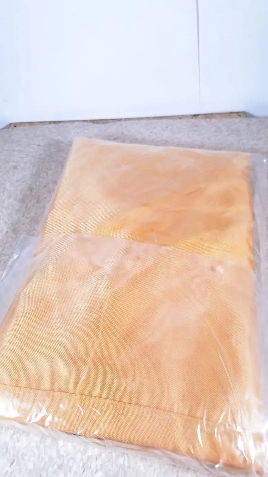Two orange fabric pillowcases neatly folded in clear packaging for guldmann repositioning sling max 500 kg use