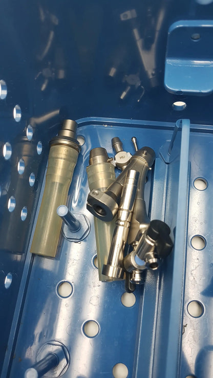 Gyrus acmi endoscopic surgical instrument set featuring metallic silver and brass surgical handpieces with various connectors