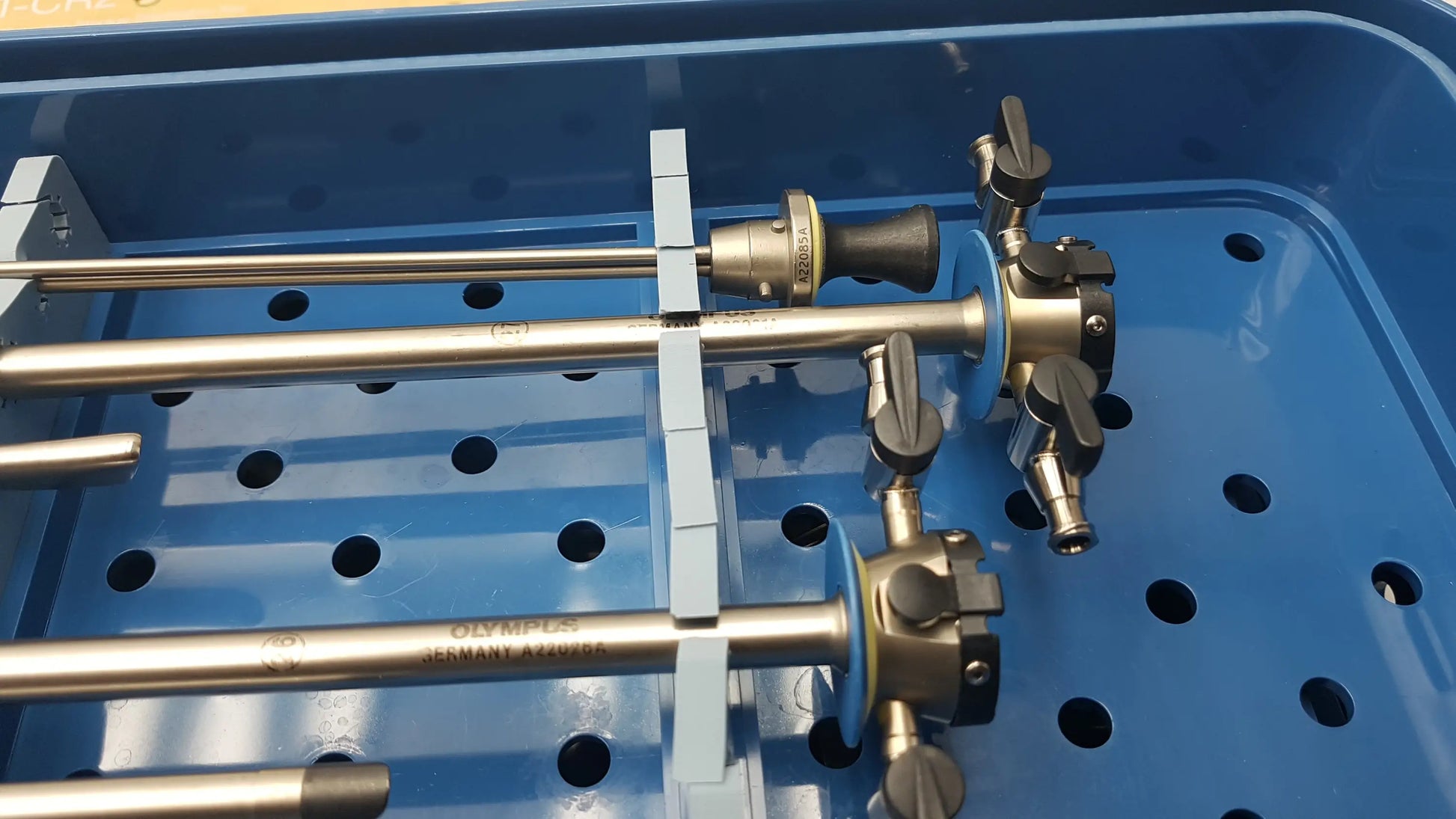 Gyrus acmi endoscopic surgical instrument set with metallic shafts and black handles branded olympus germany