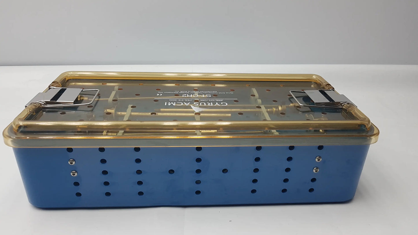 Gyrus ACMI endoscopic surgical instrument set with blue perforated tray, gold clamps, and transparent lid