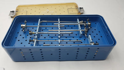 Blue perforated surgical instrument tray with metallic tools organized in compartments for gyrus acmi endoscopic instrument set