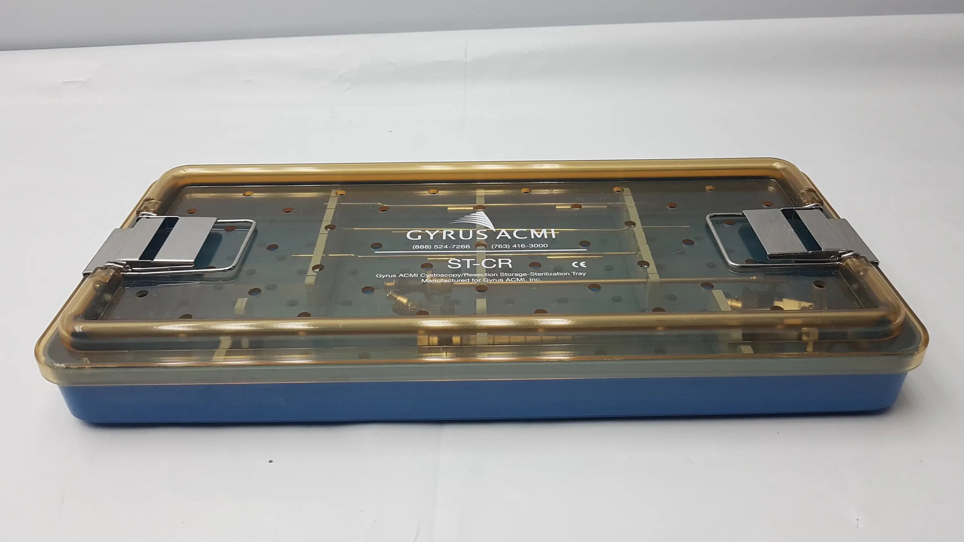 Blue and gold endoscope sterilization tray with silver metal clasps featuring olympus a3551 urethrotome sheath and obturator