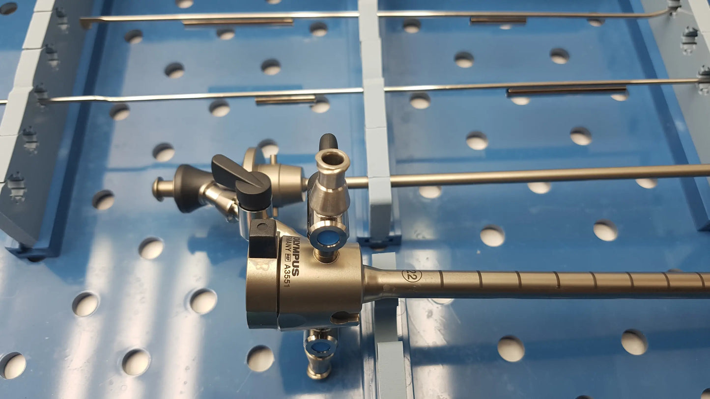 Metallic surgical instrument with textured handle and connection ports in gyrus acmi endoscope sterilization tray with olympus a3551 urethrotome sheath