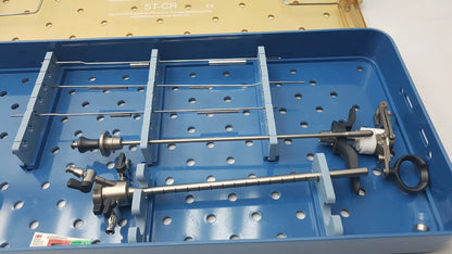 Blue surgical endoscope sterilization tray holding metallic olympus a3551 urethrotome with a3551 urethrotome sheath and obturator