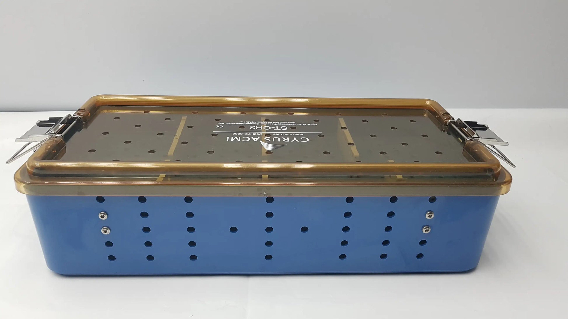Blue gyrus acmi endoscope storage tray with gold metal lid and perforated sides for sterilization use