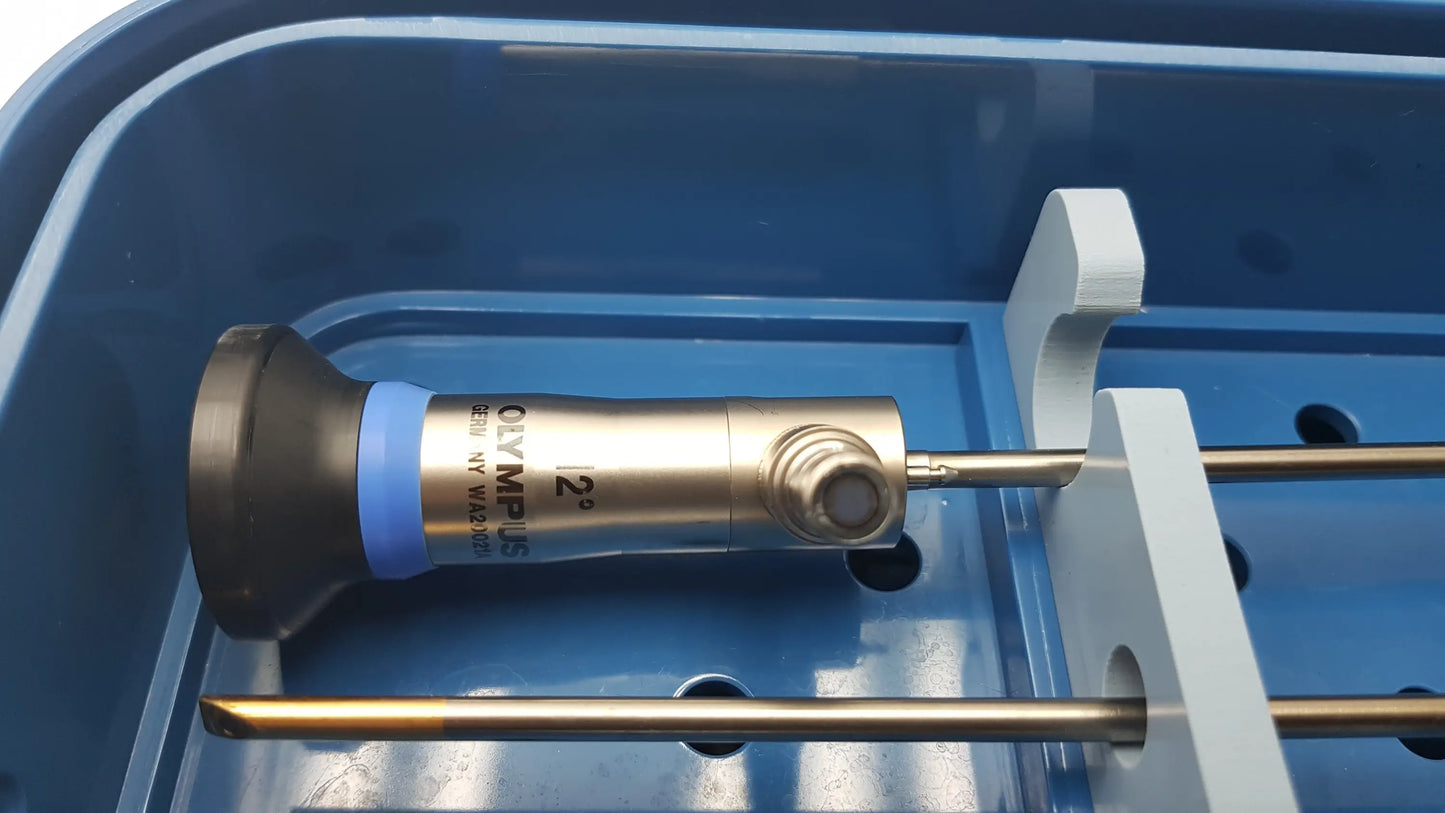 Olympus telescopes endoscope with metallic body and black tip resting in blue gyrus acmi st-cr2 endoscope storage sterilization tray