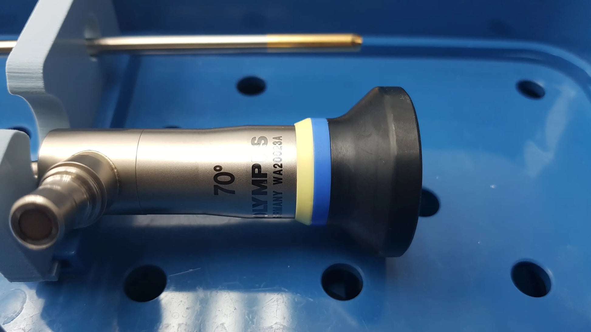 Silver olympus 70° endoscope with black and yellow-blue striped tip in gyrus acmi st-cr2 endoscope storage sterilization tray
