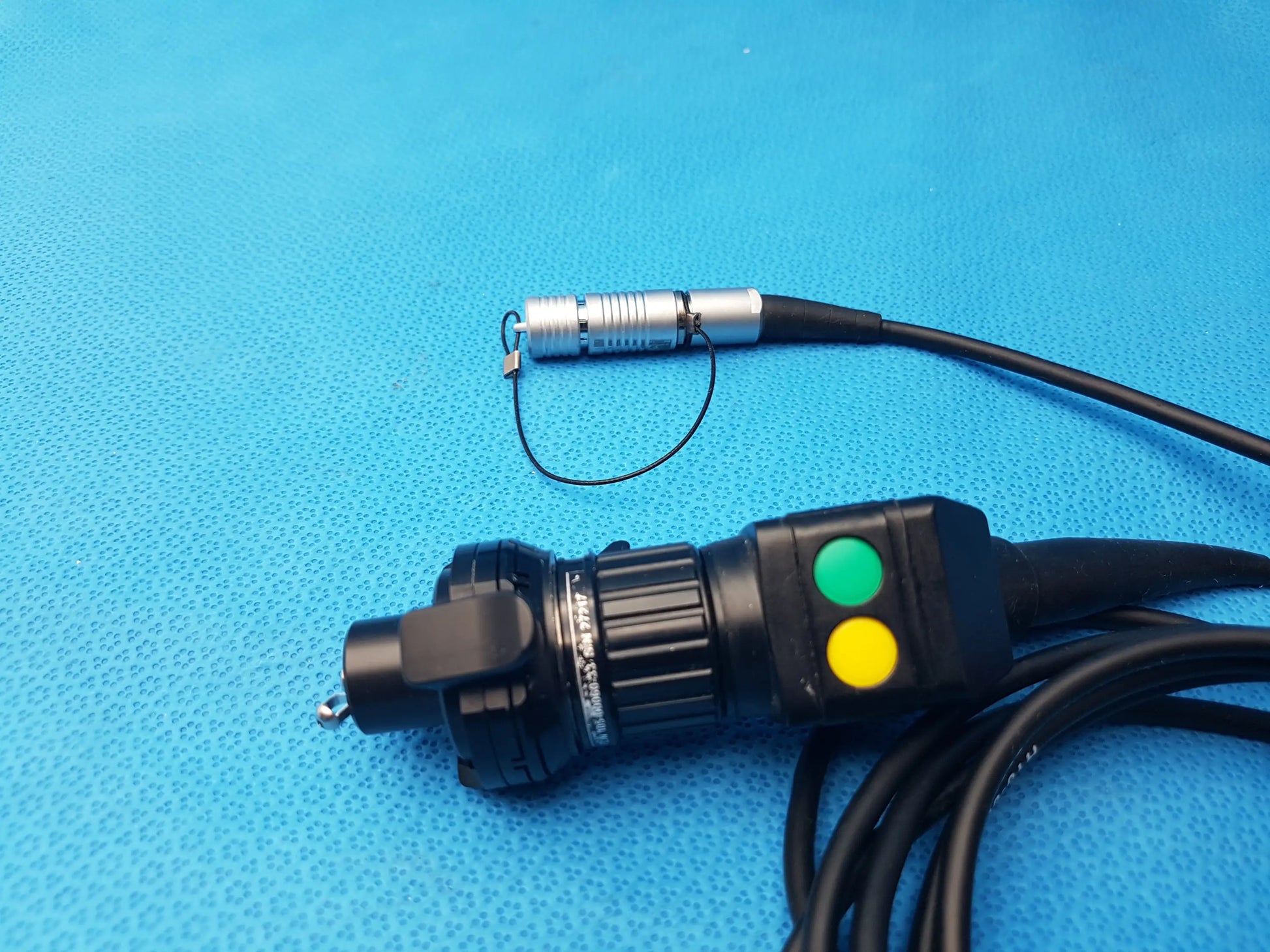 Black and silver H10-0008 IPX7 compatible endoscopic camera head with green and yellow buttons on handle and cable