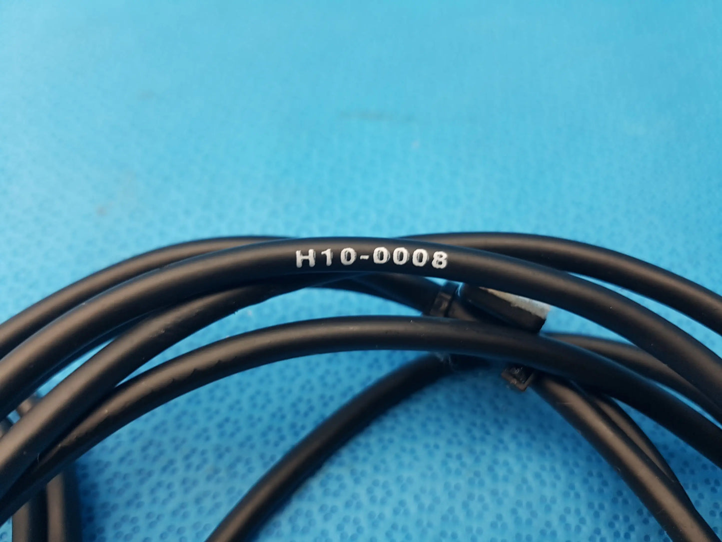 Black coiled cable with white printed identifier h10-0008 for compatible endoscopic camera head ipx7 device