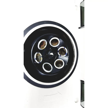 Black circular component of hamilton bell vanguard v6500 6-cell centrifuge with six silver-rimmed openings containing dark substance