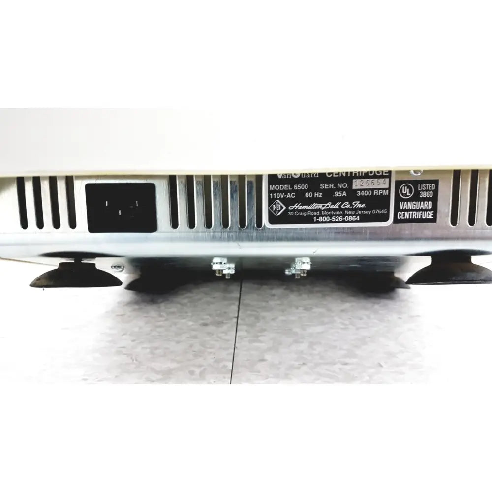 Silver metallic hamilton bell vanguard bell vanguard v6500 6-cell centrifuge with black rubber feet and model 6500 label