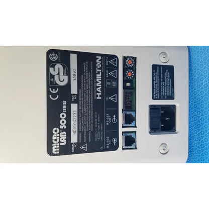 White plastic hamilton microlab 500 series diluter dispenser with black labeling and ethernet ports on back side