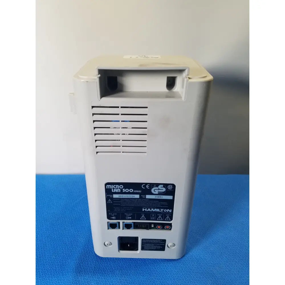 White plastic hamilton microlab 300 series syringe pump dispenser back panel with vents and multiple ports visible