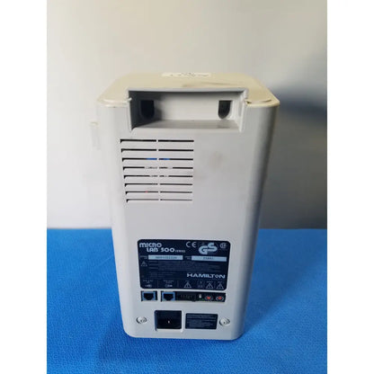 White plastic hamilton microlab 300 series syringe pump dispenser back panel with vents and multiple ports visible