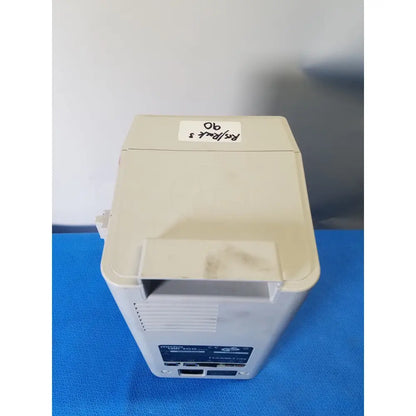 Beige hamilton medical mini-100 portable oxygen concentrator with labeled sticker on top in hamilton microlab 500 series syringe pump dispenser