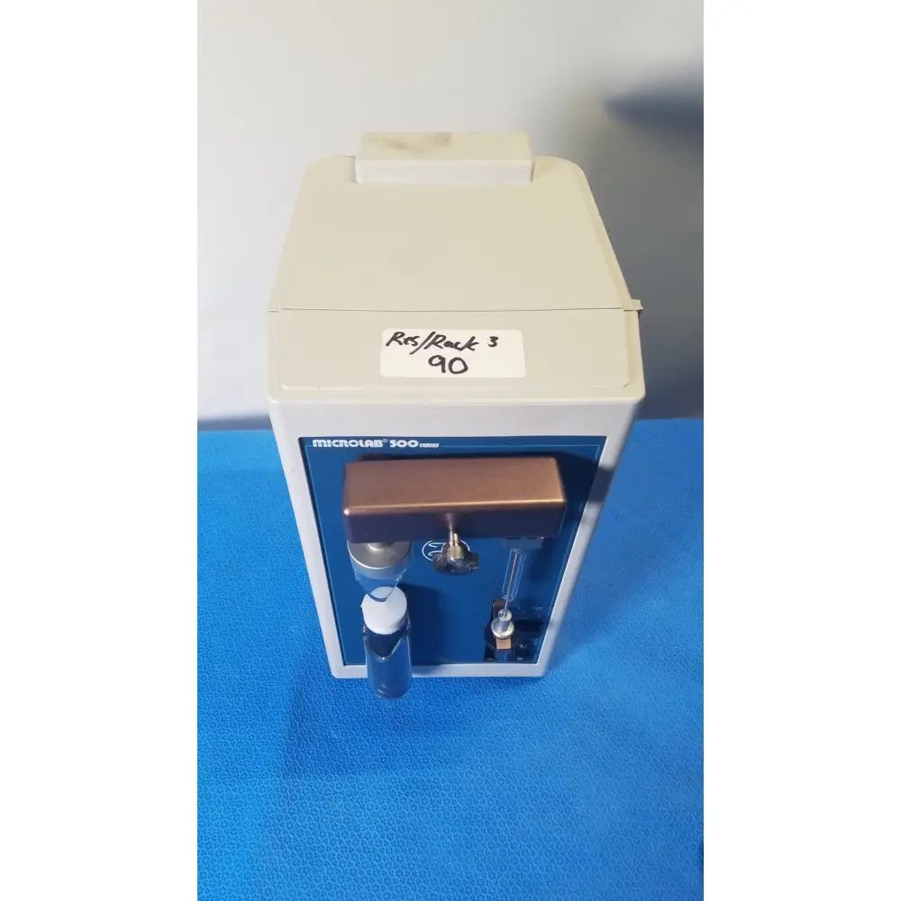 Beige and blue Hamilton microlab 300 series syringe pump dispenser with brass-colored handle for precise fluid delivery