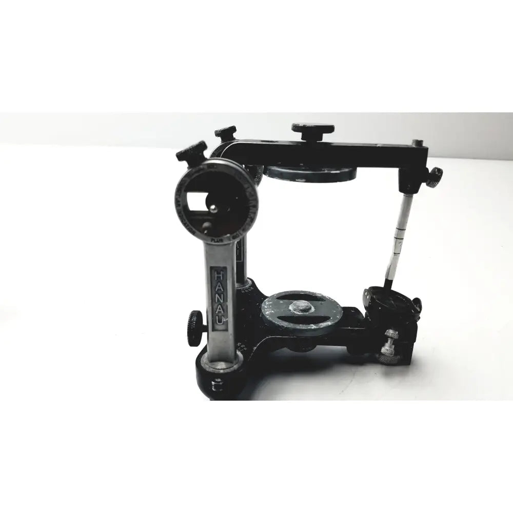 Black and silver hanau semi-adjustable dental modular with chrome articulator featuring adjustable arms and precision knobs