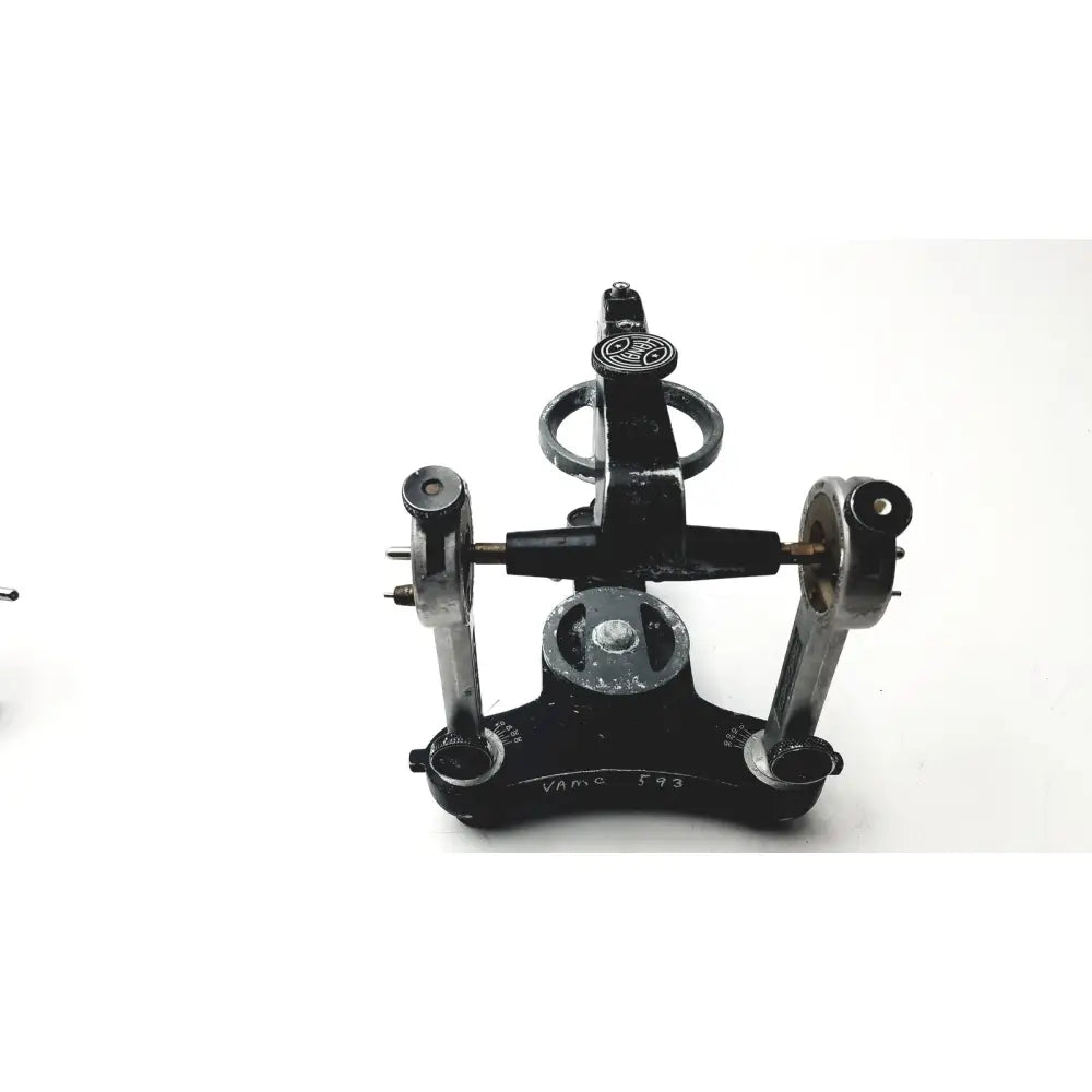 Black metal theodolite with engraved markings and central dial on hanau semi-adjustable dental chrome articulator
