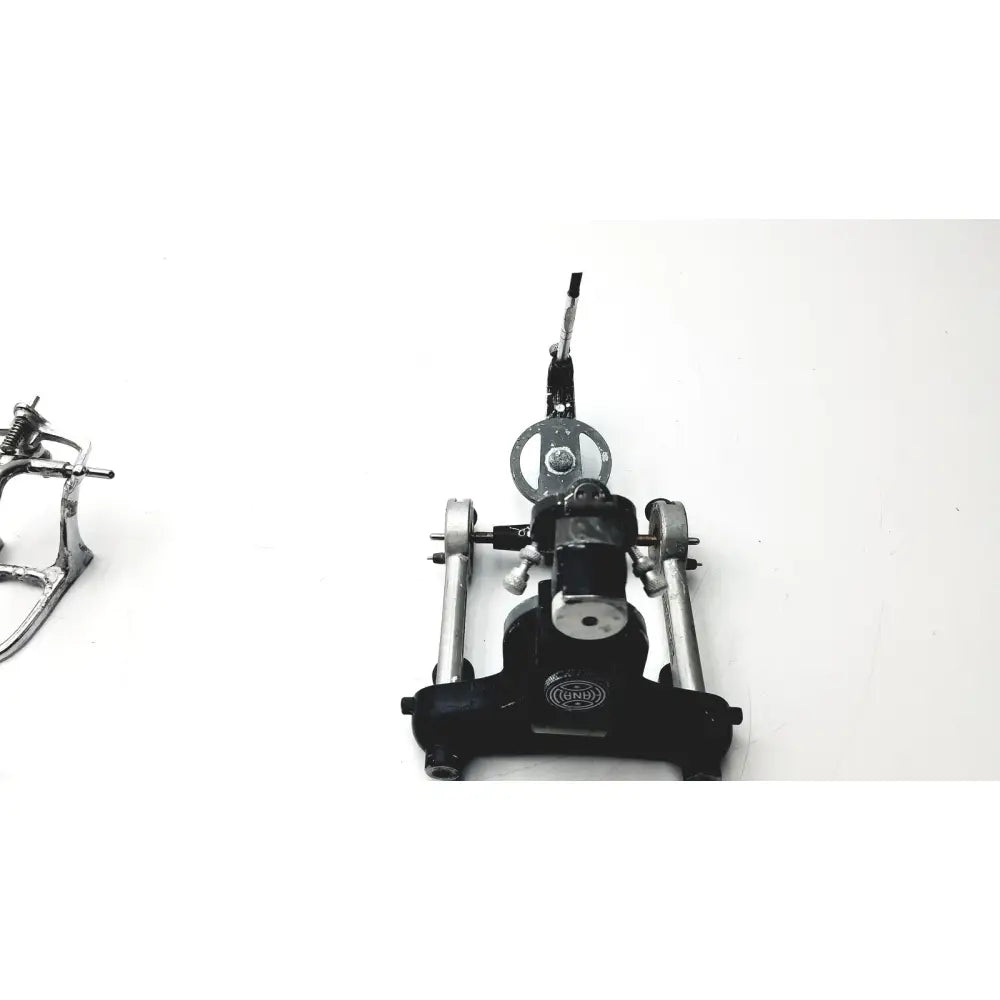Black and silver metal drum pedal with circular footplate and adjustable lever for hanau semi-adjustable dental modular chrome articulator